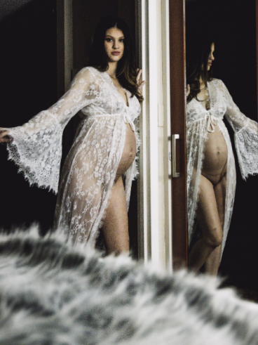 Christina poses for a maternity boudoir photo.